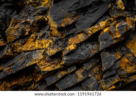black rock background with gold  / yellow colored rocks -