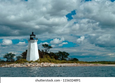 Black Rock Harbor Lighthouse, Also Referred To As Fayerweather Island Lighthouse, Is Illuminated By The Sun Though The Clouds.