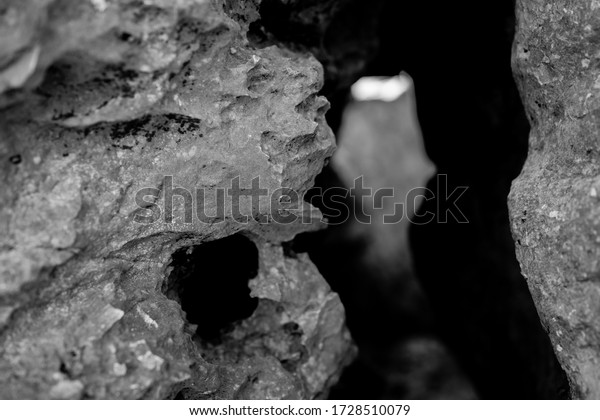 Black rock rough natural mineral stone background,\
closeup view