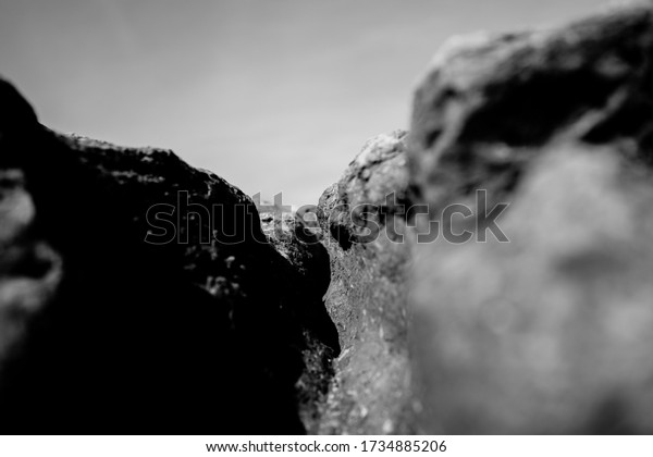 Black rock rough natural mineral stone background,\
closeup view