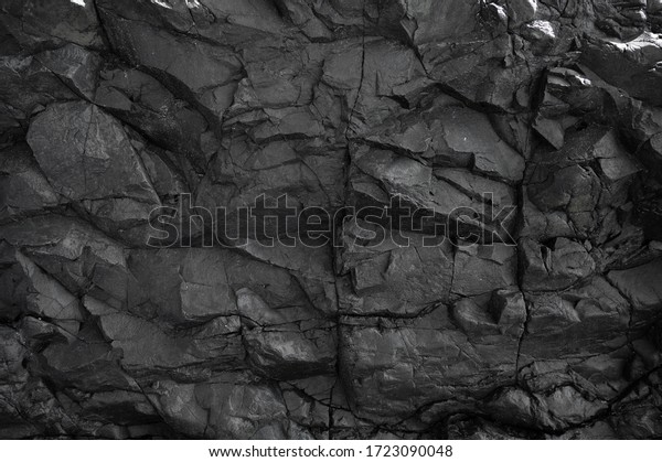 Black rock, stone, textured. Background for\
design. Hard light.