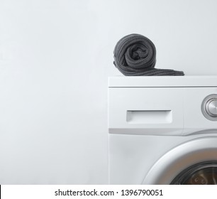 Black Rolled sweater on the washing machine