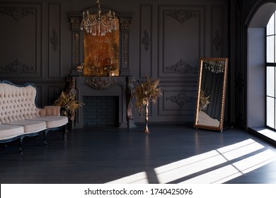 Black room interior with a vintage sofa, chandelier, mirror and fireplace - Shutterstock ID 1740425096