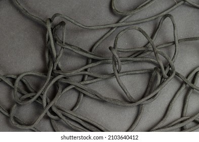 Black rope chaotically on a black background.  Close-up. Selective focus. - Shutterstock ID 2103640412