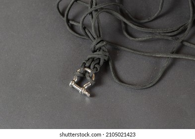 Black rope chaotically on a black background. Paracord with rigging brace. Close-up. Selective focus. - Shutterstock ID 2105021423