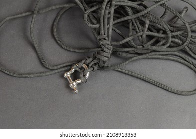 Black rope chaotically on a black background. Paracord with rigging brace. Close-up. Selective focus. - Shutterstock ID 2108913353