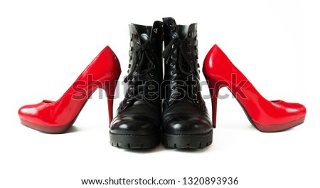 black rough man boots and red elegant woman shoes isolated on white background