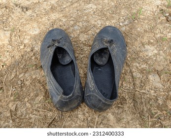black rubber farmer boots on the ground - Shutterstock ID 2312400333