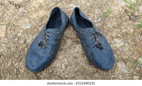 black rubber farmer boots on the ground - Shutterstock ID 2312400335