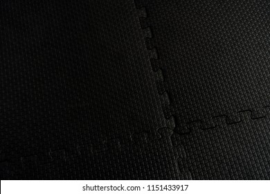 Black Rubber Floor Mat And Tiles Inside A Gym.