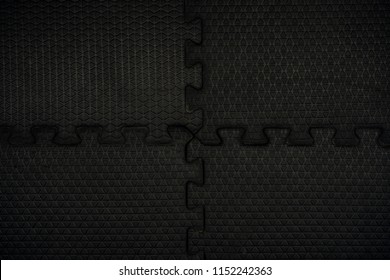 Black Rubber Floor Mat And Tiles Inside A Gym. Black Rubber Fitness Floor Texture And Background. EPDM Safety Mats Reduce The Injury Risk Caused By Falls On Playgrounds And Sport Facilities.