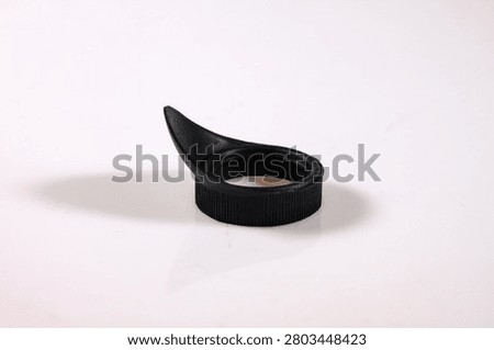 Black rubber microscope eyecup isolated on a white background. Replacement optical accessory for microscope eyepieces, providing comfortable viewing and shielding the eye from ambient light.