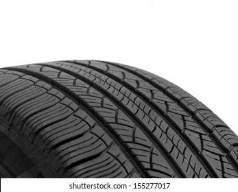 A black rubber tyre isolated against a white background