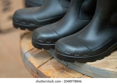 Black Rubber Work Boots On Display For Retail Sale. At An Old Fashioned Hardware Store