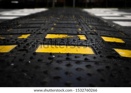 Black rubber with yellow accents and road background