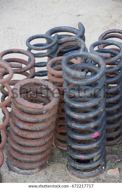 Black\
and rusted color vehicle suspension springs\
closeup