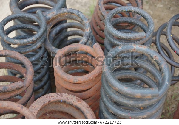 Black\
and rusted color vehicle suspension springs\
closeup