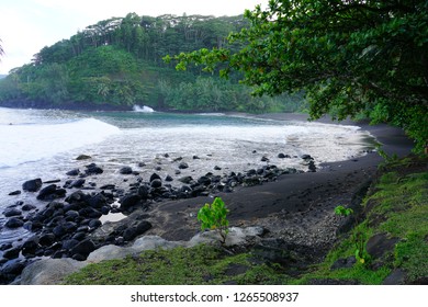 A Black Sand Beach With Lava Rocks Near The Arahoho Blowhole In Tahiti, French Polynesia