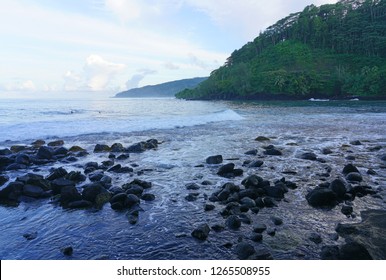 A Black Sand Beach With Lava Rocks Near The Arahoho Blowhole In Tahiti, French Polynesia