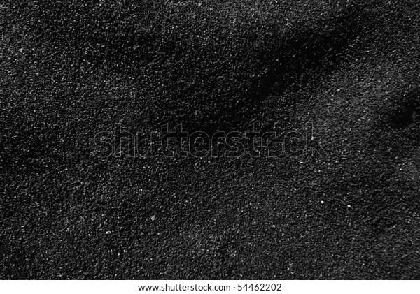Black Sand\
beach macro photography.  Shadows play in this evening B&W\
macro shot of a black sand\
beach.