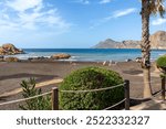 Black sand beach in the municipality of Playa in Portman, Murcia, Spain.