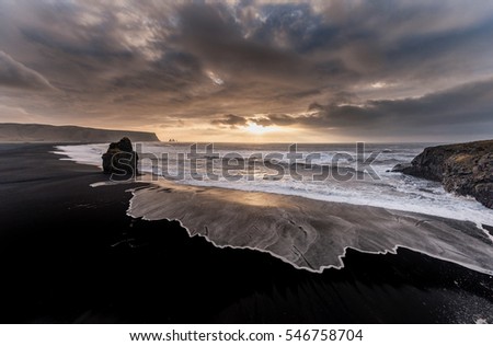 Black Sand Beach Reynisfjara in Iceland. Windy Morning. Ocean Waves. Colorful Sky. Morning Sunset.