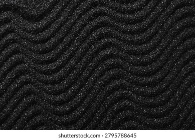 Black sand texture with wavy pattern, dark granular surface background, minimalist design element
