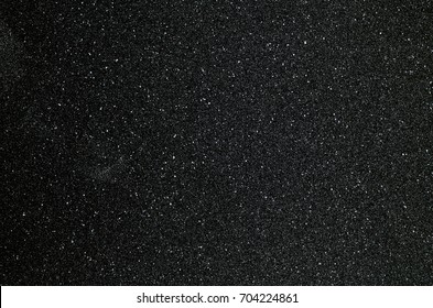 Black sandpaper to make a background image. - Shutterstock ID 704224861