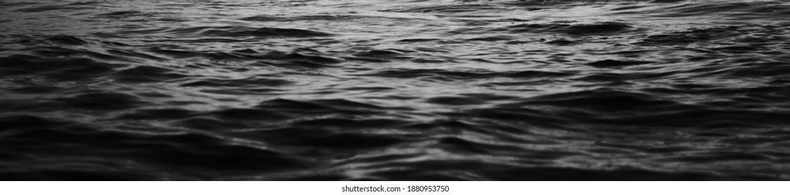 Black sea water texture. water reflection texture background. Dark background, High resolution background of dark water or oil surface. Ocean surface dark nature background. Black water texture.