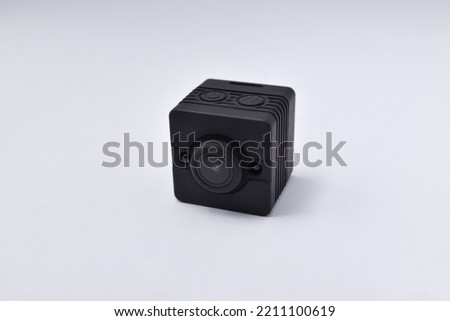 Black security camera isolated on white background. Mini spy camera