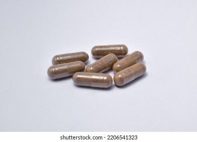 Black Seed With A Mixture Of Propolis In A Capsule. Isolated White Background. (Habbatusauda)