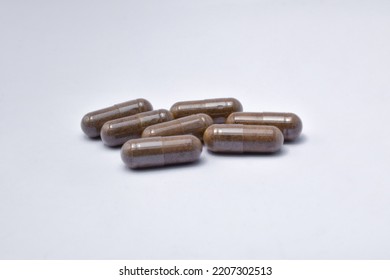 Black Seed With A Mixture Of Propolis In A Capsule. Isolated White Background. (Habbatusauda)