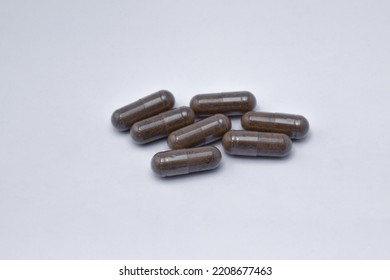 Black Seed With A Mixture Of Propolis In A Capsule. Isolated White Background. (Habbatusauda)