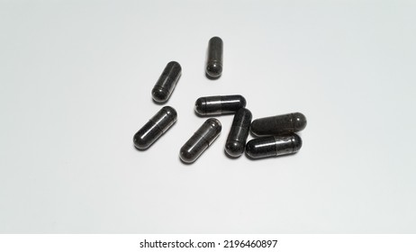 Black Seed (Nigella Sativa) Herbal Medicine. Medicine In Capsule Form On A White Background. Capsule Pill