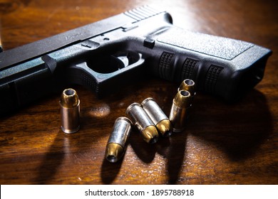 Black semi-automatic pistol on wood table