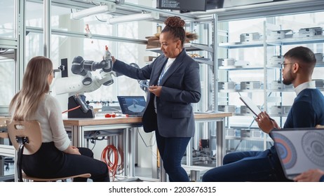 Black Senior Engineer Giving Computer Science Lecture To Diverse Multiethnic Group Of Female And Male Students. Explaining Information About Automation With Robotics Technology Concept.