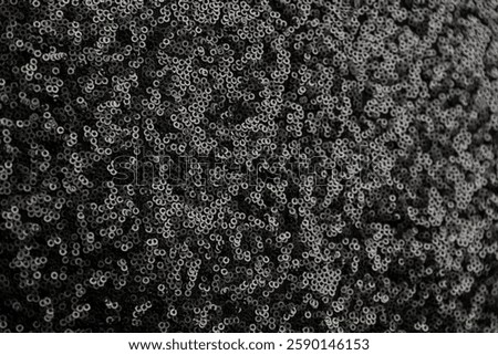 black sequin fabric texture. pattern of material with sequin in the light
