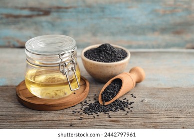 Black sesame seeds in bowl and oil in glass jar on wooden background closeup. - Powered by Shutterstock