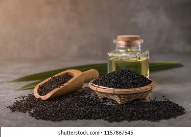 Black Sesame Seeds With Oil On Dark Background.