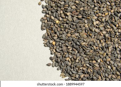 Black Sesame Seeds Scattered On A Gray Background