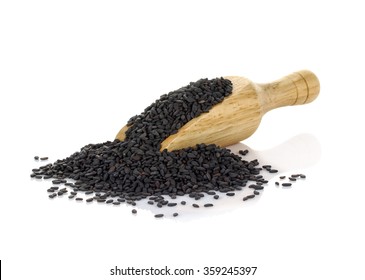 Black Sesame seeds in wooden scoop isolated on white background