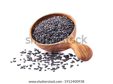 Black Sesame seeds in wooden spoon isolated on white background
