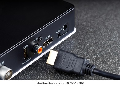 black set-top box a device for connecting to a TV next to it the hdmi cable