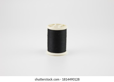 Black sewing thread Put on a white background.