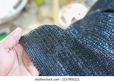 Black shading net pattern texture. Used in gardening, nurseries, agriculture. Texture, weave pattern details close up.