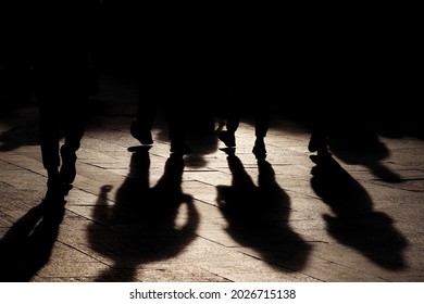 Black shadows and silhouettes of people on the street. Crowd walking down on sidewalk, concept of pedestrians, crime, society, population