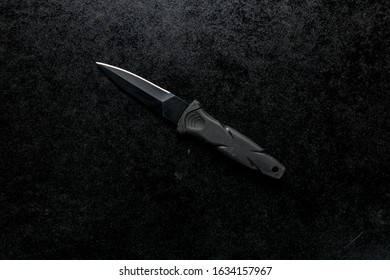 A black sharp small knife with black handle