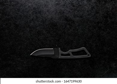 A black sharp small knife with black handle