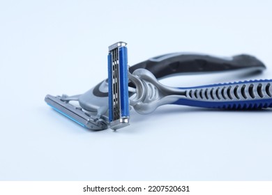 Black shaving razor and blue shaving razor isolated on white background, standing sideways