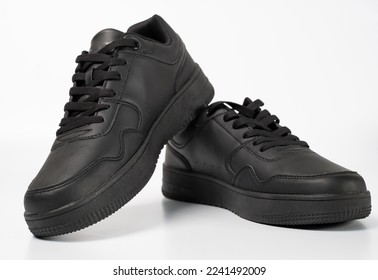 Black shoes isolated on white background. A pair of black sneakers.